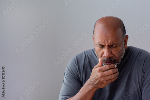 Older African American man not feeling well.