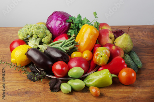 Fototapeta Naklejka Na Ścianę i Meble -  Fresh vegetables eggplant, tomatoes, cucumbers, peppers, green beans on a wooden table.