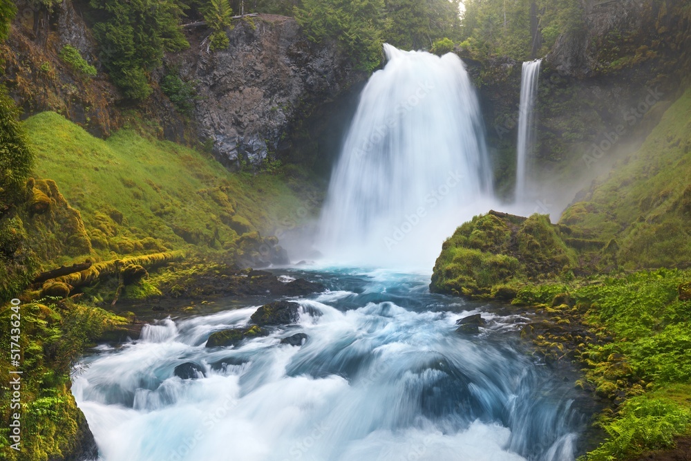 Koosah Falls, also known as Middle Falls, is second of the three major waterfalls of the McKenzie River, in the heart of the Willamette National Forest, in the U.S. state of Oregon. Sunny day in fores Koosah Falls, also known as Middle Falls, is second of the three major waterfalls of the McKenzie River, in the heart of the Willamette National Forest, in the U.S. state of Oregon. Sunny day in fores