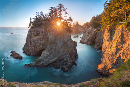 Sunset at Natural Bridges along Samuel H. Boardman State Scenic Corridor, Oregon during a golden hour sunset - sunbeams through trees with dense vegetation.
Beautiful seascape with rocks. West Coast  photo