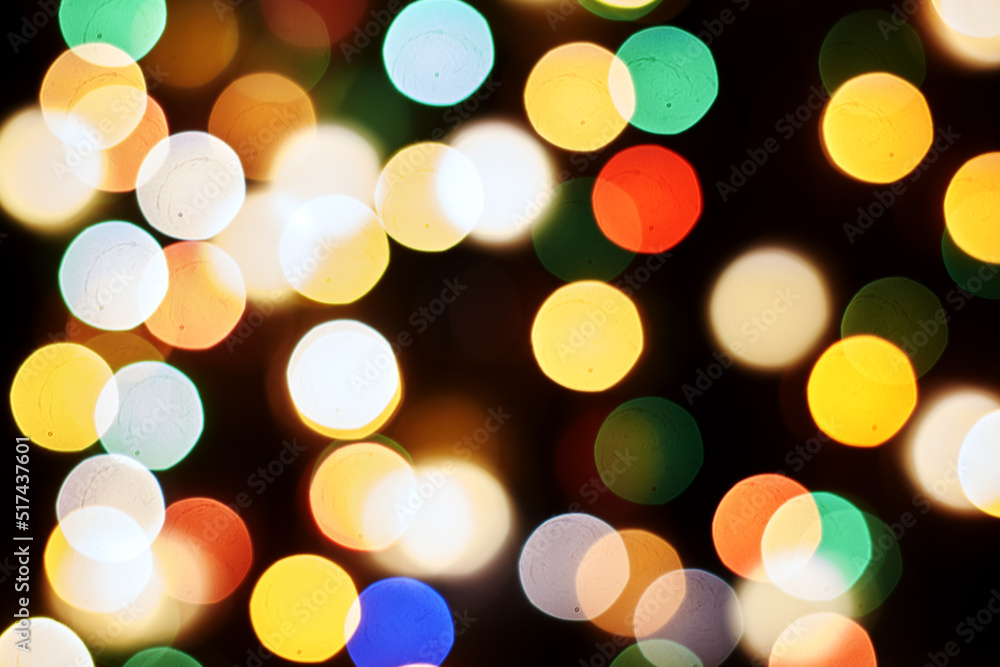 Fototapeta premium multicolored festive lights on a black background screensaver backdrop