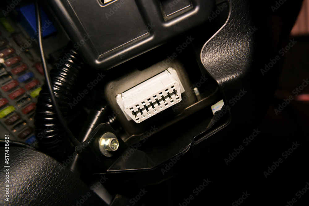 OBD2 port for vehicle electronic diagnostic under the car dashboard