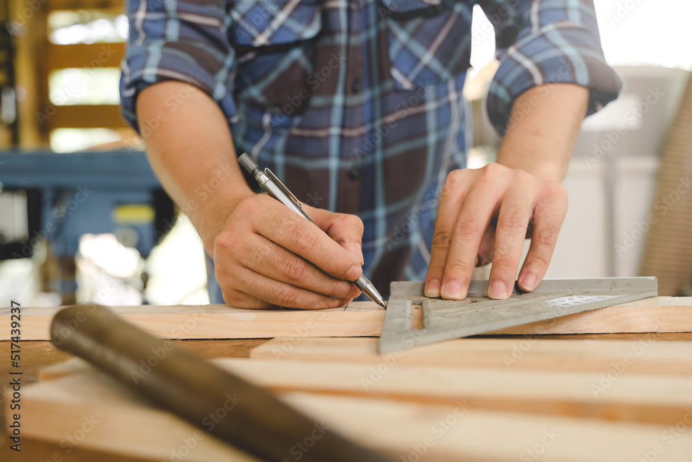 Hands of person doing diy project at home. Man measuring wood to doing cabinet craftworks as a hobby. Hands of person doing diy project at home. Man measuring wood to doing cabinet craftworks as a hobby.