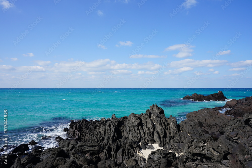 rock coast and clear bluish sea