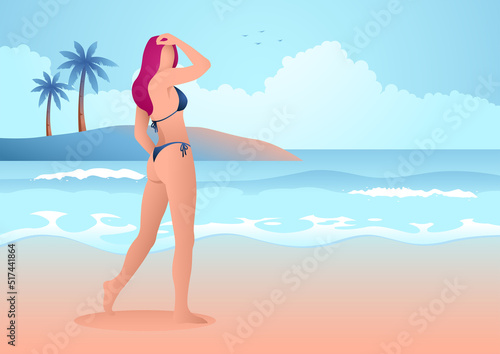 Beautiful woman in blue bikini posing on the beach