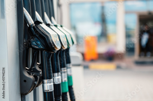 Closeup of woman pumping gasoline fuel in car at gas station Fototapet