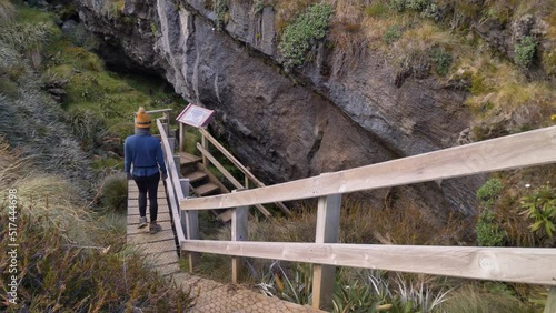 Slider, person descends stairs to Luxmore Cave, Kepler Track side trip, New Zealand photo