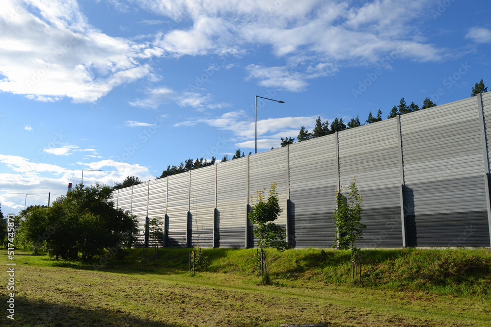 A noise barrier (also called a soundwall, noise wall, sound berm, sound barrier, or acoustical barrier) is an exterior structure designed to protection of people against noise.