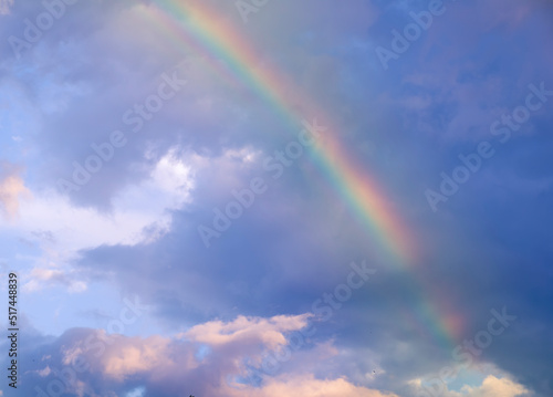amazing bright rainbow in beautiful evening cloudy sky after rain and thunder  weather concept