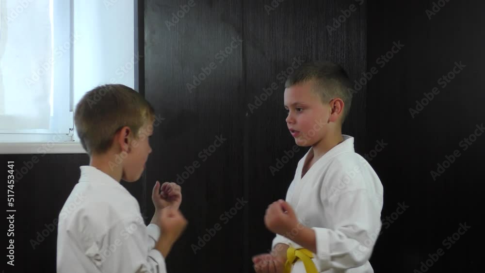 Two athlete boys train active paired exercises with hands Two athlete boys train active paired exercises with hands