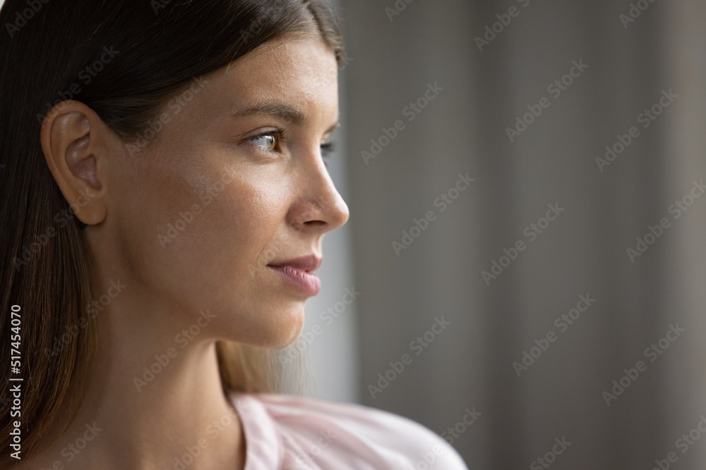 Profile view beautiful face serious young 30s woman. Close up thoughtful female staring into distance looks pensive, deep in thoughts. Daydream, eyesight care, laser vision correction services concept Profile view beautiful face serious young 30s woman. Close up thoughtful female staring into distance looks pensive, deep in thoughts. Daydream, eyesight care, laser vision correction services concept
