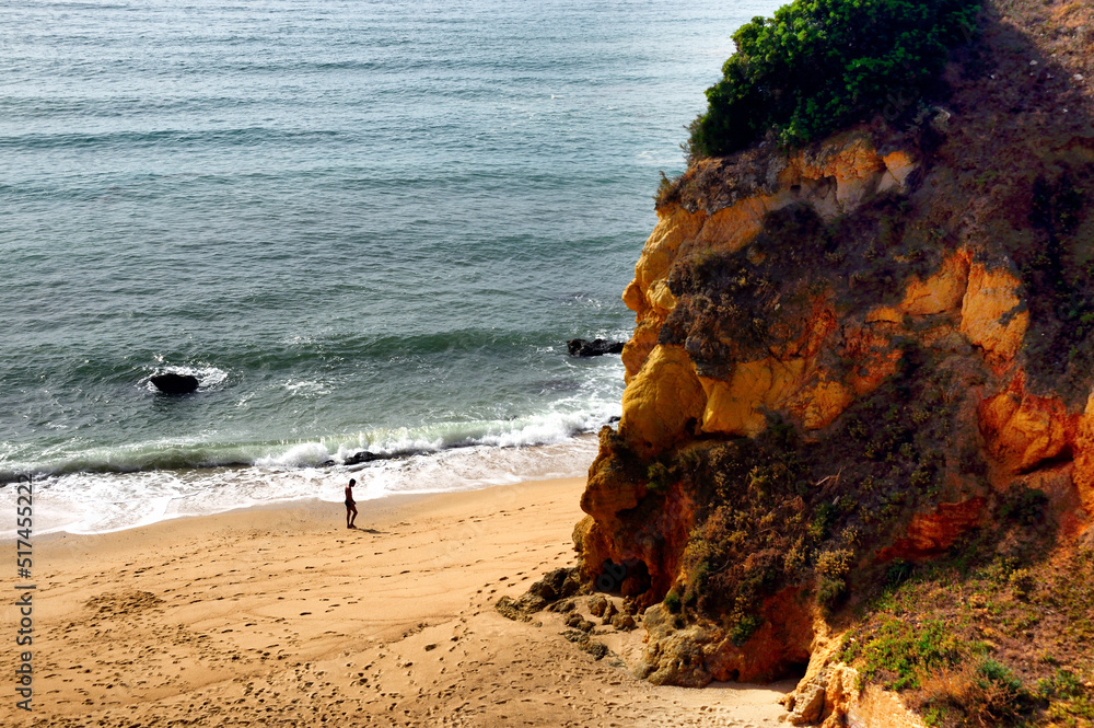 single man walking on empty beach, Pinhao beach, Lagos, Western Algarve, Portugal, Europe