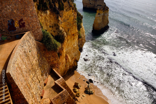 steps leading from high cliffs  to small sandy Pinhao beach, Lagos, Algarve, Portugal, Europe