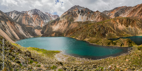 Blue glacial lake high in the mountains. Atmospheric green landscape with a lake in a high-altitude valley. Altai Mountains.