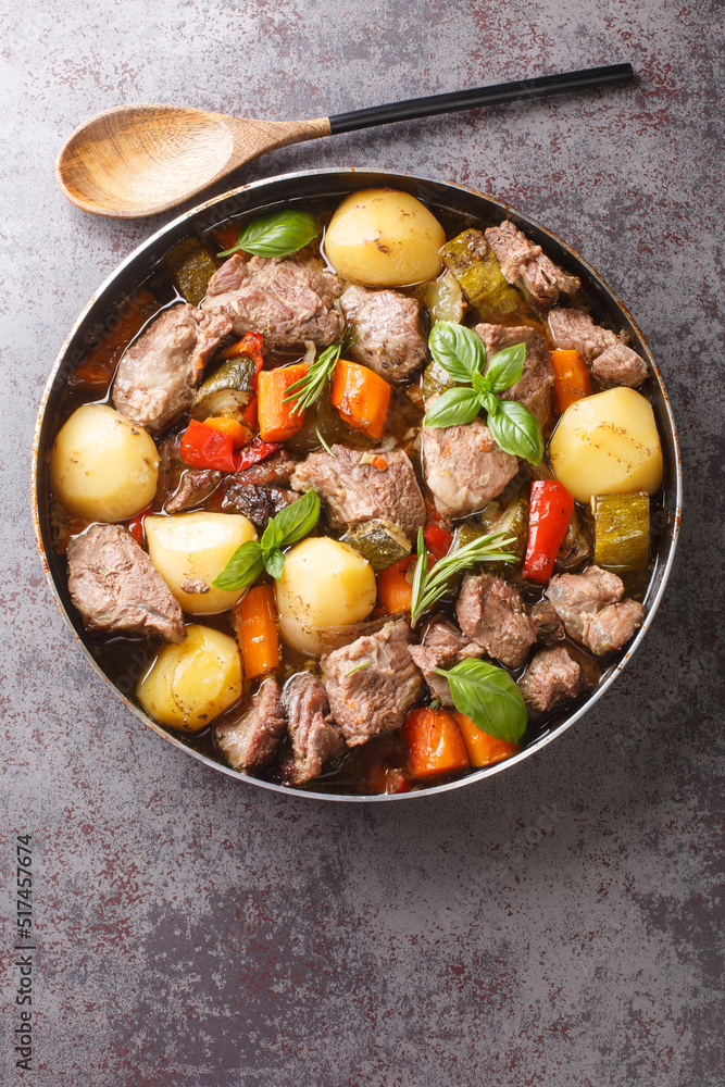 Peka Croatian Meat and Vegetable Stew close-up on the table. Vertical top view from above