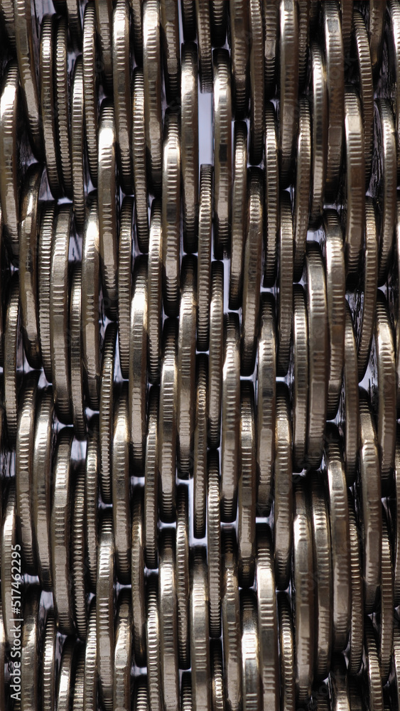Money wall. Chaotic pile of coins close up. Nickel coin texture. Vertical business background made of many coin edges. Economy finance and bank backdrop. Tax and credit. Mobile phone wallpaper. Macro Money wall. Chaotic pile of coins close up. Nickel coin texture. Vertical business background made of many coin edges. Economy finance and bank backdrop. Tax and credit. Mobile phone wallpaper. Macro