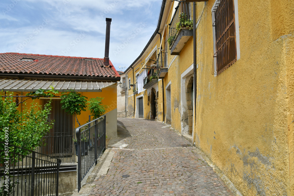Fototapeta premium A narrow street between the old houses of Albano di Lucania, a village in the Basilicata region, Italy.