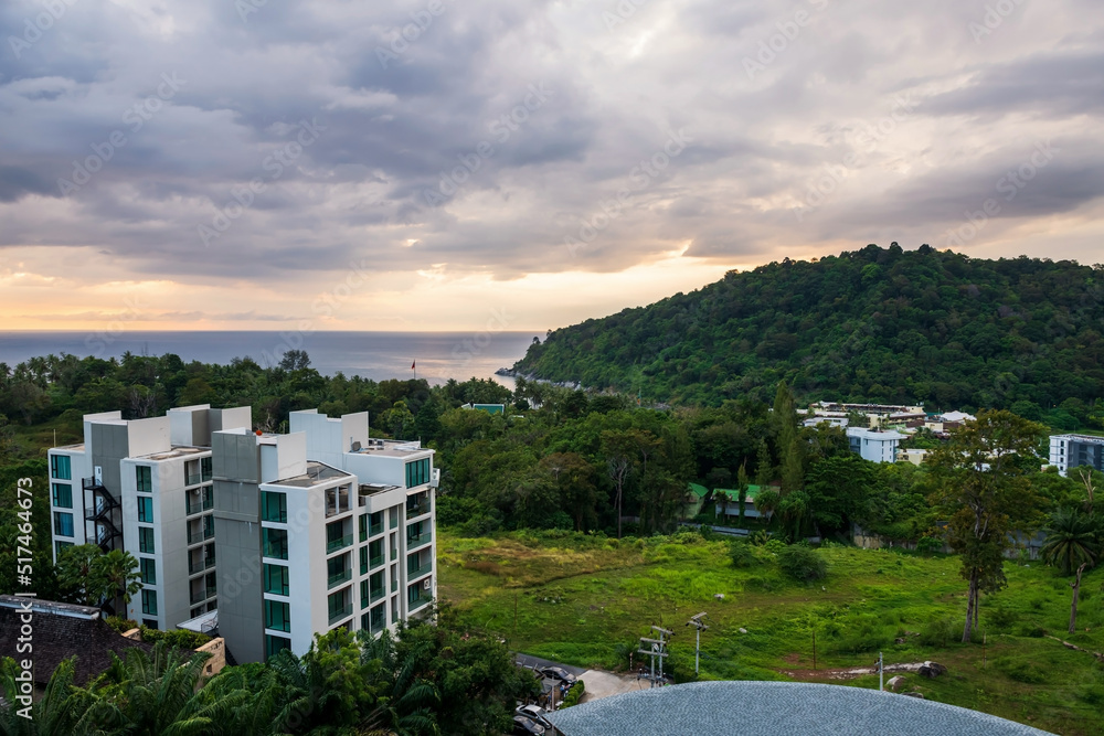 hotel or condo on hill with view of Phuket coast at sunset hotel or condo on hill with view of Phuket coast at sunset