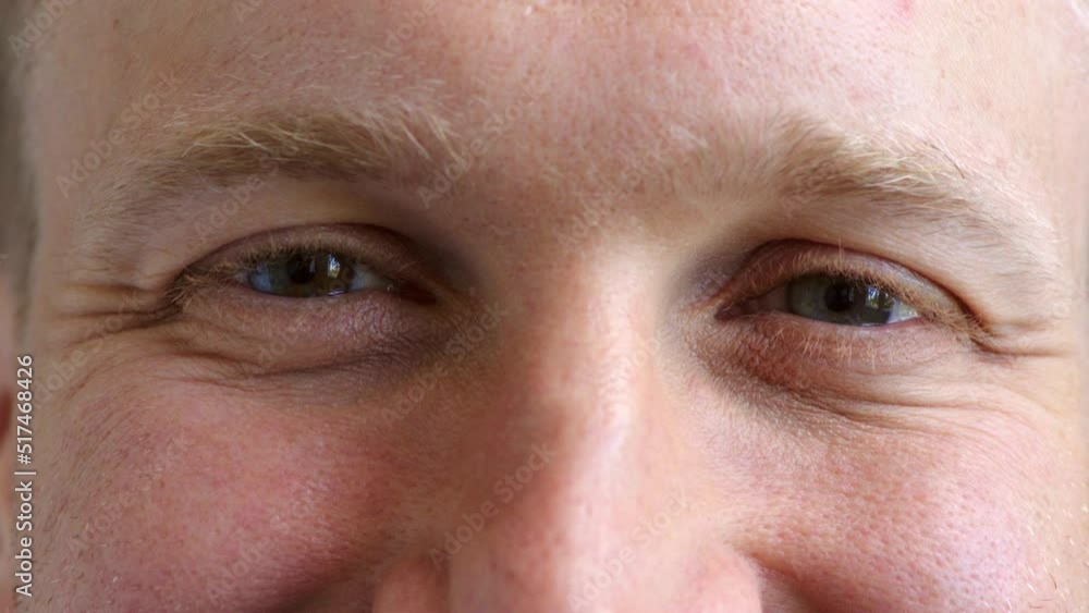 Closeup face of a mans eyes wearing contact lenses to improve his vision. Portrait of a guy with stunning blue eyes and good eyesight and smile lines. Cheerful male with a positive attitude Closeup face of a mans eyes wearing contact lenses to improve his vision. Portrait of a guy with stunning blue eyes and good eyesight and smile lines. Cheerful male with a positive attitude