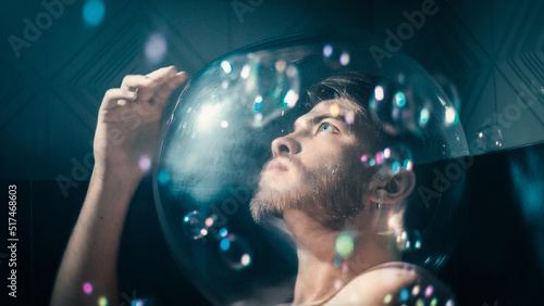 Thoughtful man alone wrapped in soap bubbles