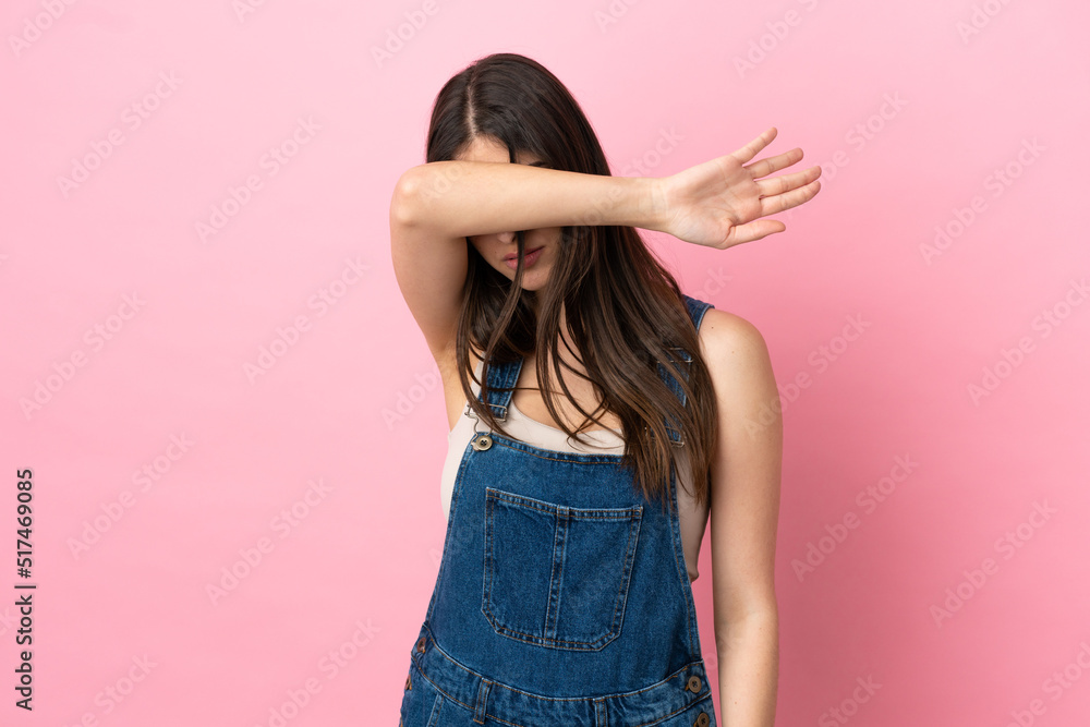 Young caucasian woman isolated on pink background covering eyes by hands Young caucasian woman isolated on pink background covering eyes by hands