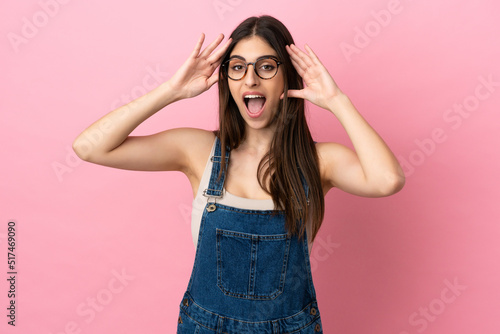 Young caucasian woman isolated on pink background with surprise expression
