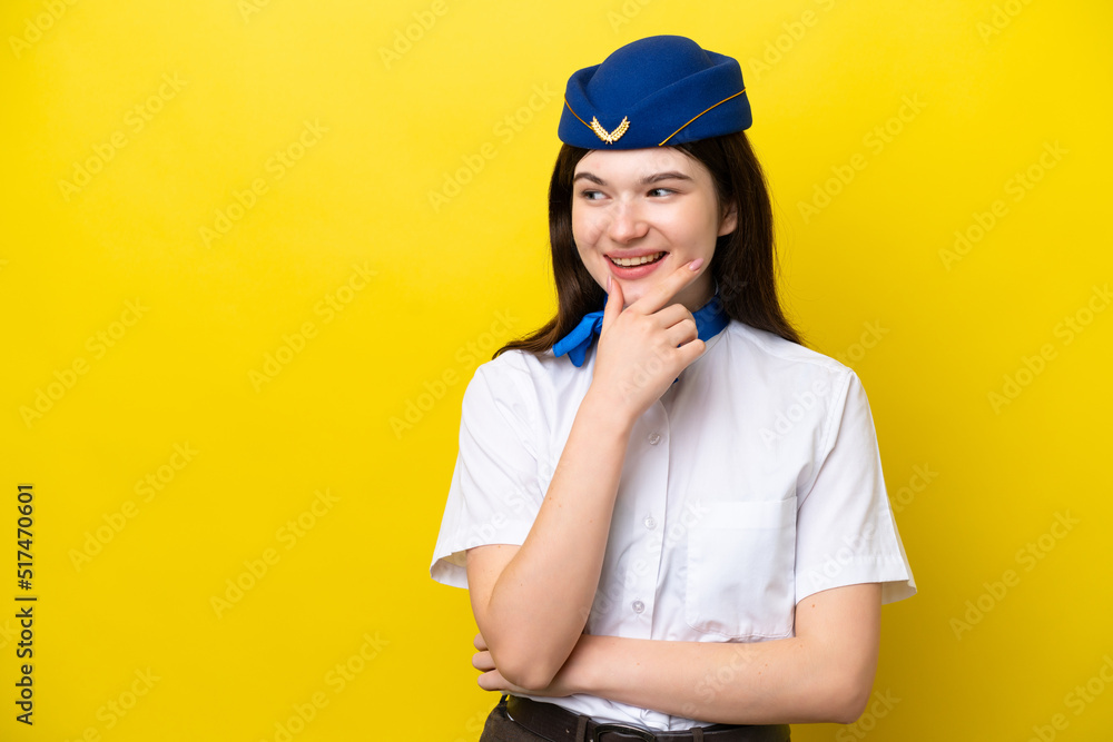 Airplane stewardess Russian woman isolated on yellow background looking to the side Airplane stewardess Russian woman isolated on yellow background looking to the side