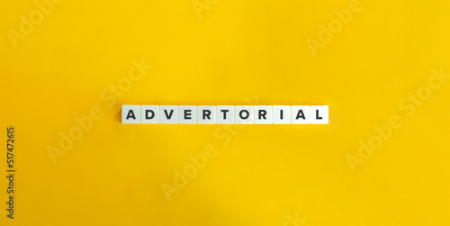 Advertorial Word on Block Letter Tiles on Yellow Background. Minimal Aesthetics.
