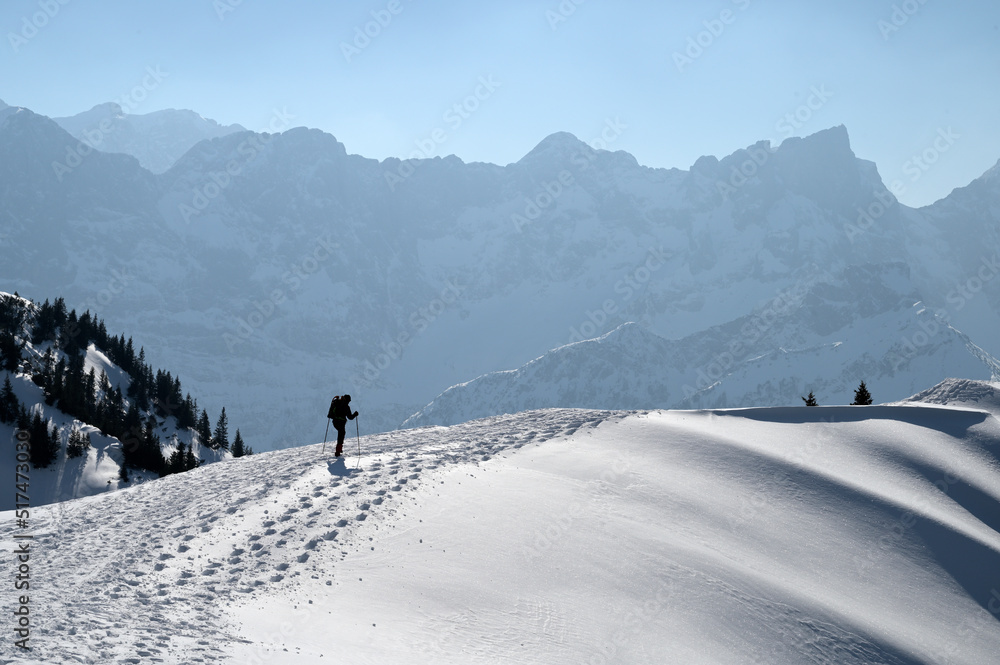Hiker on top of a a mountain in winter in the Karwendel mountains, Alps, Tirol, Austria