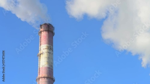 Electricity, gas, manufacturing , World pollution concept. Factory chimney blowing smoke from pipe in blue sky background. Industrial smoke from chimney