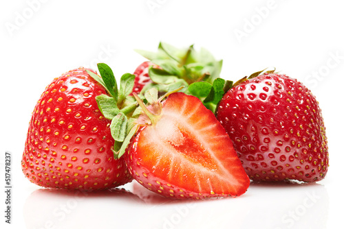 strawberries isolated on white background, red berries whole and sliced in details, concept of fresh fruits and healthy food, macro photo