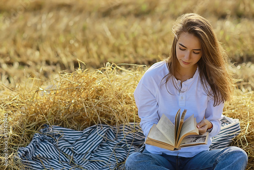 female reading a book in a field summer straw woman reading a book student studying summer vacation from school girl in the field