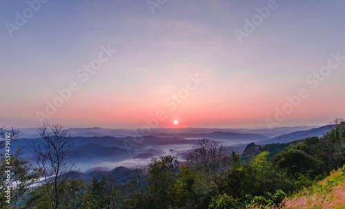  The view from the mountain with the morning sunrise, beautiful, with a thin mist on the ground with the color of the sky being twilight. © Khomsan