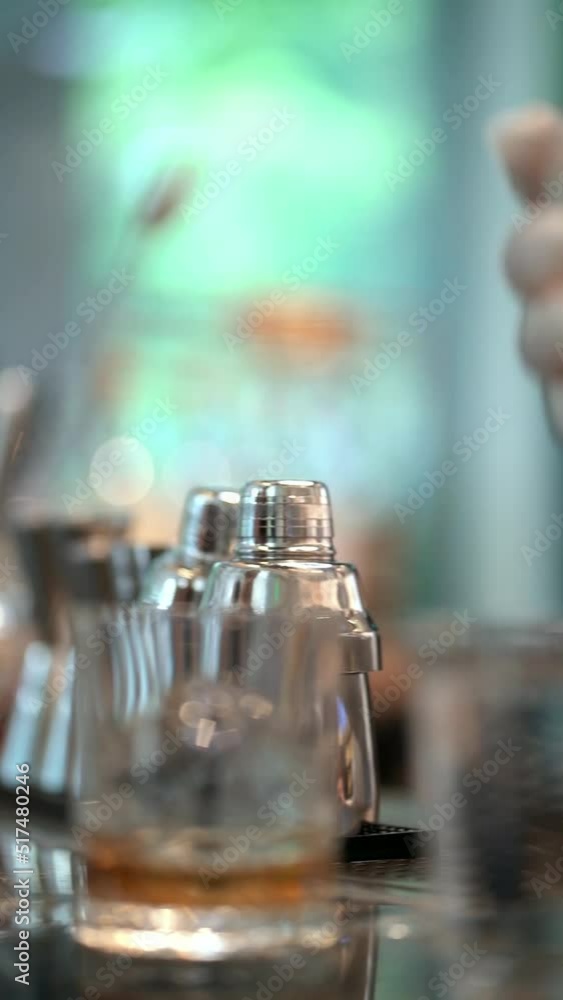 closeup shot of female hand pouring whisky into a glass closeup shot of female hand pouring whisky into a glass