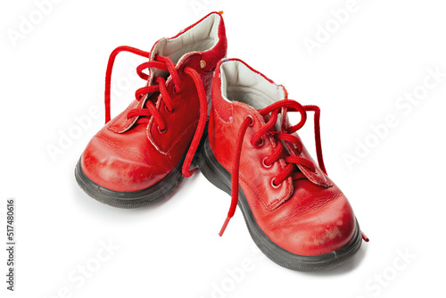 Worn out kiddie-size red lace-ups. Children's shoes with laces. Old ankle boots for small kid.
