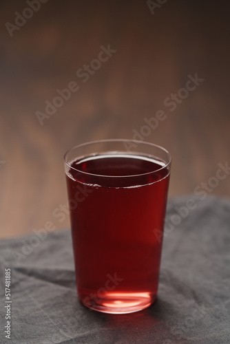 berry drink in thin glass on wood table with copy space