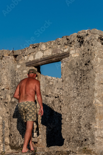 Ksamil, Albania A male tourist visits the Ali Pasha Ottoman castle at the inlet of Lake Butrint. © Alexander