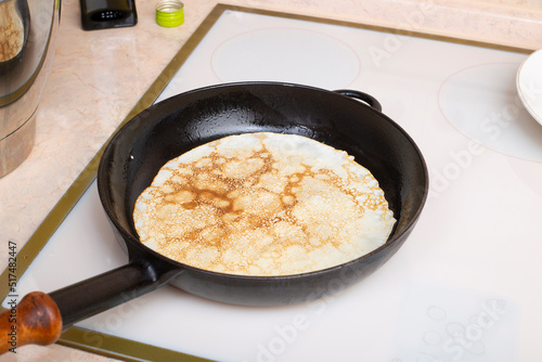 Cooking pancakes from batter in a cast iron pan