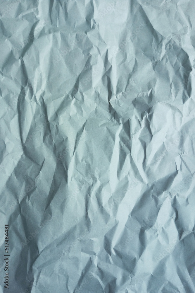 Obraz premium Gray crumpled a paper. Vertical photo. Background texture.