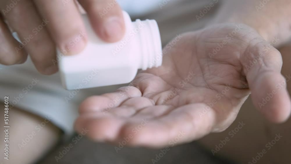 Senior adult man holding painkiller pills on male hand pouring capsules from meds bottle or pack taking medicine, old elderly grandfather health care, pharmacy and treatment concept, close up view Senior adult man holding painkiller pills on male hand pouring capsules from meds bottle or pack taking medicine, old elderly grandfather health care, pharmacy and treatment concept, close up view
