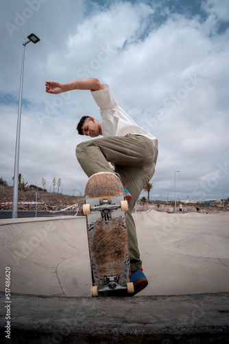 young skater makes a trick called 