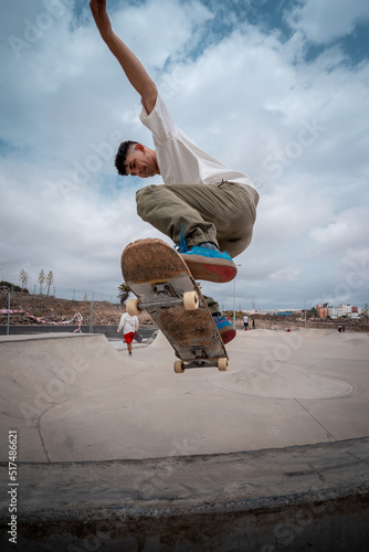 young skateboarder makes a trick called 