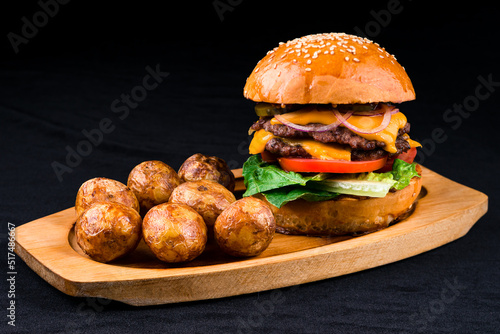 american burger set with french fries on a wooden board