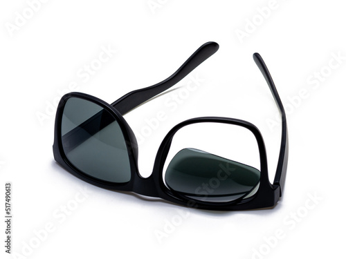Black broken sunglasses, the lens fell out of the frame, isolated on white