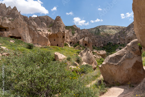 Landscape of the Red Valley of Cappadocia, with the volcanic mountains in the area and the blue sky full of white clouds.