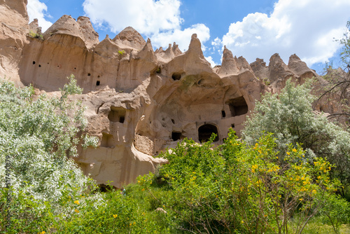 Landscape of the Red Valley of Cappadocia, with the volcanic mountains in the area and the blue sky full of white clouds.