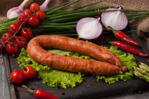 boiled and smoked pork balyk sausage decorated with fresh vegetables