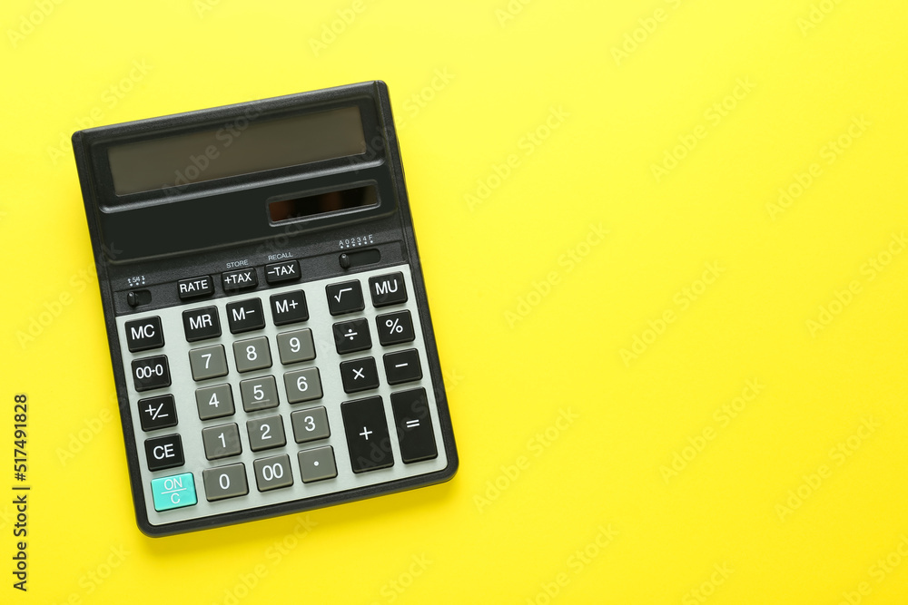 Modern calculator on yellow background, top view. Space for text Modern calculator on yellow background, top view. Space for text