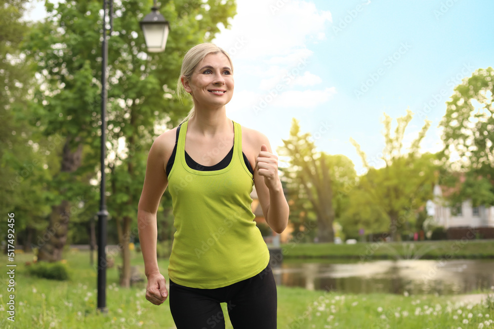 Beautiful woman jogging around park in morning Beautiful woman jogging around park in morning