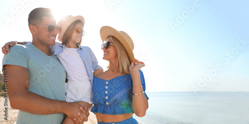 Happy family at beach on sunny summer day, space for text. Banner design
